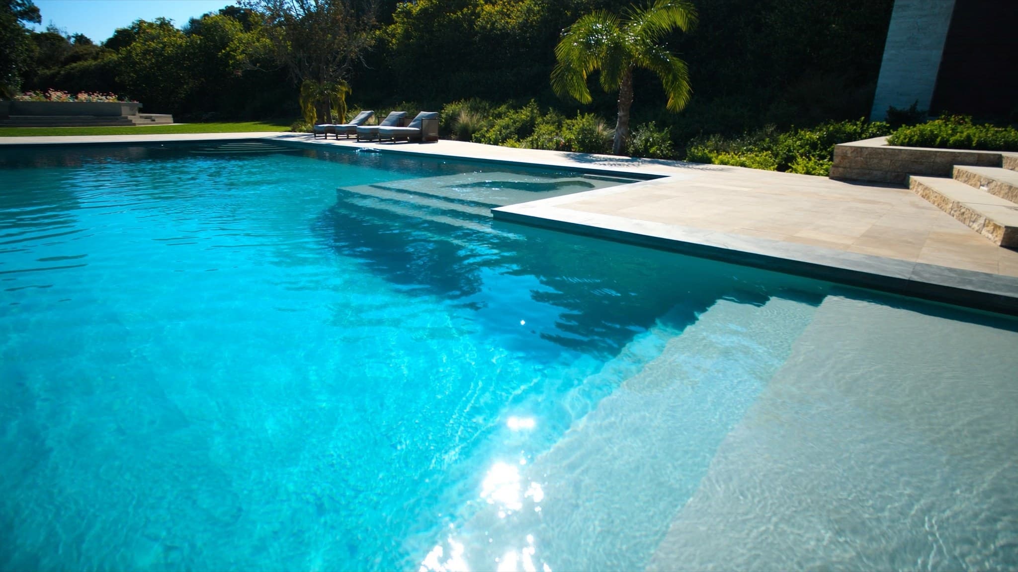 Crystal-clear backyard swimming pool at golden hour
